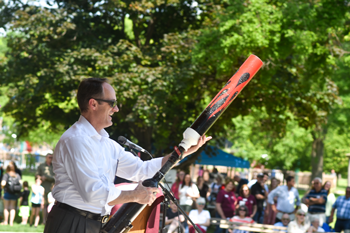 William Newton Hospital CEO launches KSOK Radio t-shirts into the crowd at the ‘Afternoon in the Park’ celebration at Island Park.